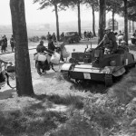 Bren gun carriers pass Belgian refugees on the Brussels-Louvain road, 12 May 1940